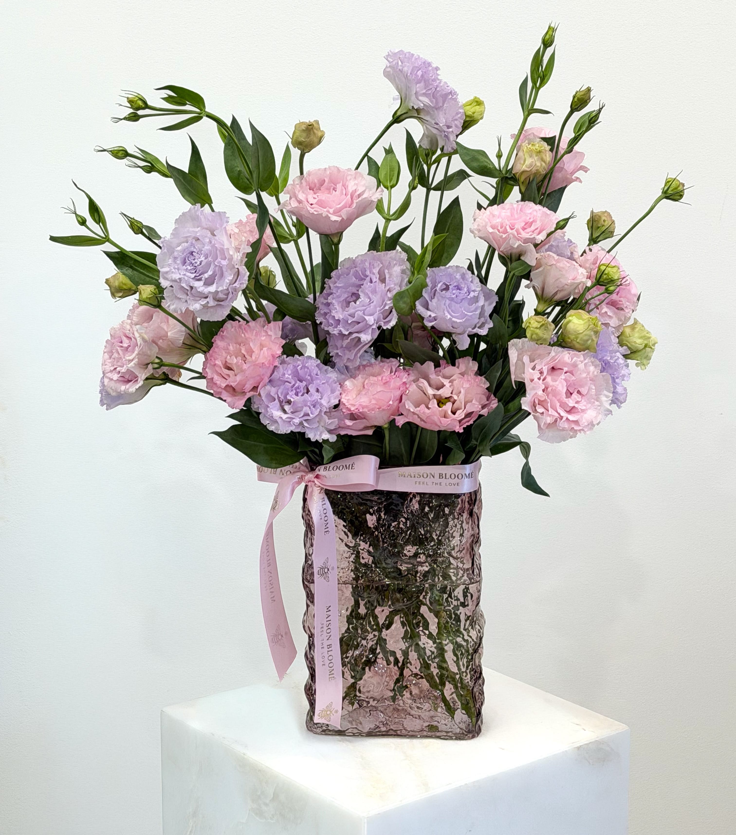     Pastel lisianthus arrangement in textured blush glass vase by Maison Bloomé Adelaide