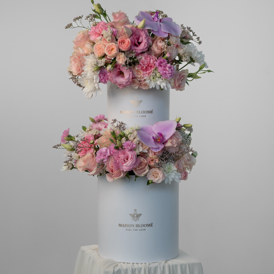 Floral arrangement in a white box on a gray background