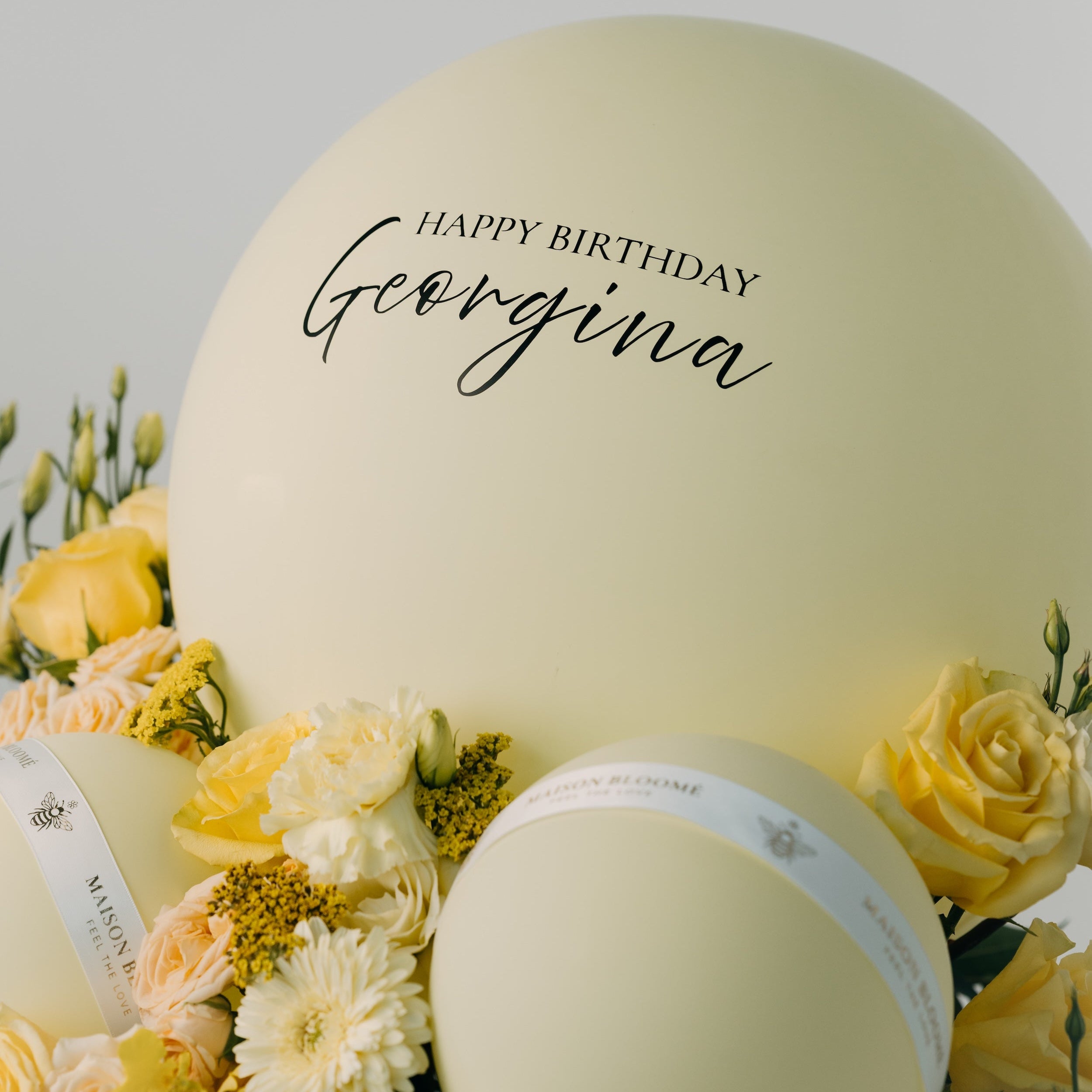 Close-up of yellow rose birthday arrangement with balloons by Maison Bloomé Adelaide florist