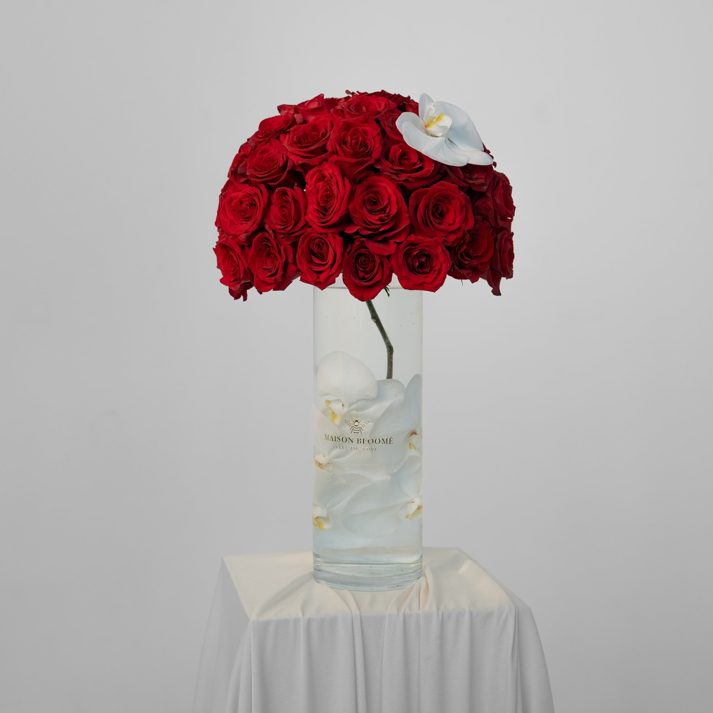 Elegant red rose arrangement with orchid in glass vase by Maison Bloomé florist Adelaide