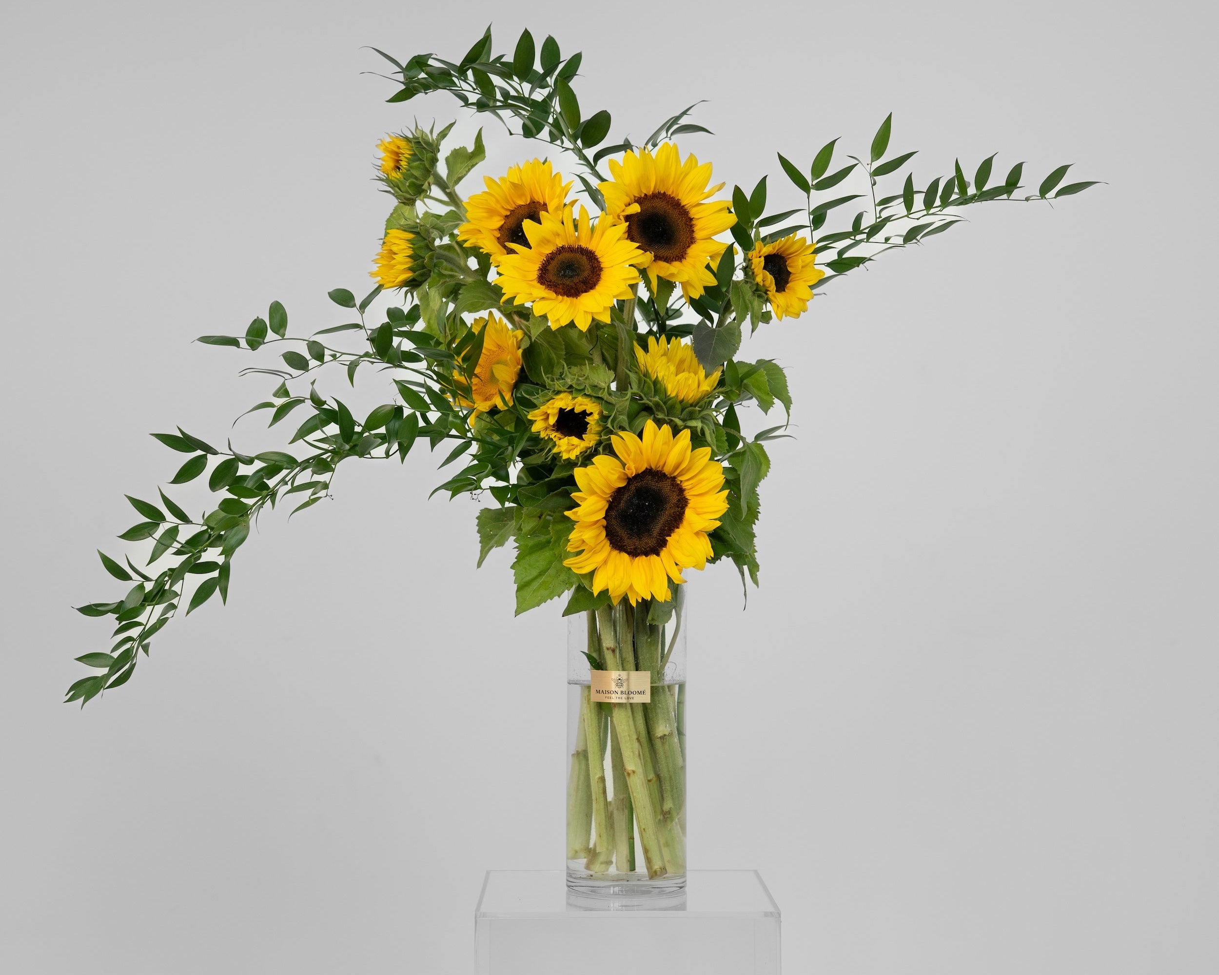 Fresh sunflower arrangement in glass vase with greenery by Maison Bloomé Adelaide florist